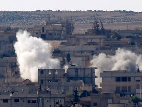 Smoke rises from the Syrian town of Kobani, seen from near the Mursitpinar border crossing on the Turkish-Syrian border in the southeastern town of Suruc, Sanliurfa province, October 5, 2014. REUTERS/Umit Bektas