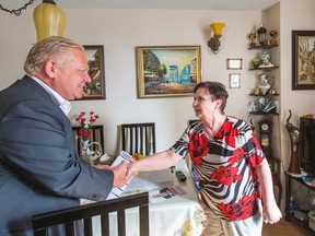 Mayoral candidate Doug Ford meets with Ludmila Alieva as he campaigns at a senior's residence TCHC building in North York on Sunday, October 5, 2014. (Ernest Doroszuk/Toronto Sun)