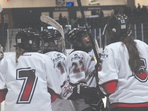 Members of the Central Plains Capitals Female AAA Midget team celebrate a goal during the Caps win over Norman Oct. 5. (Kevin Hirschfield/The Graphic)