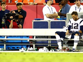 Tom Brady #12 of the New England Patriots sits on the sidelines late in the fourth quarter during the game against the Kansas City Chiefs at Arrowhead Stadium on September 29, 2014 in Kansas City, Missouri.  (Dilip Vishwanat/Getty Images/AFP)