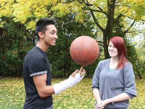 Kamisha watches as Najaf spins the basketball at 360 Kids on Friday, Oct. 3, 2014. The program is funded by Hockey Helps the Homeless. (Veronica Henri/Toronto Sun)