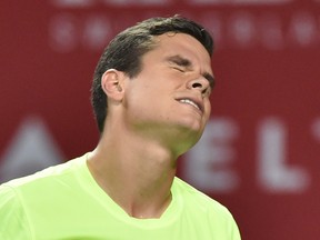 Milos Raonic of Canada reacts after losing a point against Kei Nishikori of Japan during their men's singles final at the Japan Open tennis tournament in Tokyo on October 5, 2014. Nishikori won 7-6 (7/5), 4-6, 6-4. (AFP PHOTO / KAZUHIRO NOGI)