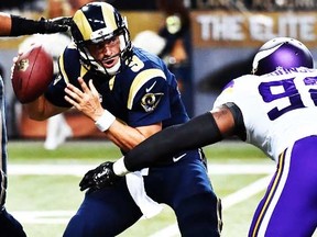 St. Louis Rams quarterback Austin Davis (9) looks to pass the ball under pressure from Minnesota Vikings defensive tackle Tom Johnson (92) during the second half at the Edward Jones Dome.  (Jasen Vinlove-USA TODAY Sports)