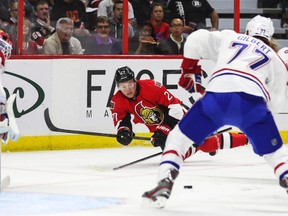 Ottawa Senators' Curtis Lazar makes a pass while airborne against the Montreal Canadiens' during NHL pre-season hockey action at the Canadian Tire Centre in Ottawa, Ontario on Friday October 3, 2014. Errol McGihon/Ottawa Sun/QMI Agency