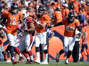 Denver Broncos quarterback Peyton Manning (18) celebrates his 500th touchdown pass with tight end Julius Thomas (80) in the first quarter against the Arizona Cardinals at Sports Authority Field at Mile High. (Ron Chenoy-USA TODAY Sports)