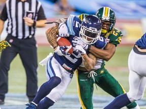Argonauts’ Chad Owens gets tackled by the Eskimos’ Marcell Young on Saturday. The Argos improved to 5-8 with the win. (Ernest Doroszuk/Toronto Sun)