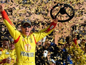 Joey Logano celebrates after winning the Hollywood Casino 400 at Kansas Speedway on Sunday. (Getty Images/AFP)