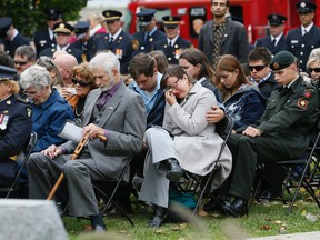 Caitlin James, 29, and her family, mourn the loss of husband and father Kevin James, who was a volunteer fire fighter with the Southwold Fire Department. (STAN BEHAL, Toronto Sun)