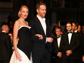 Ryan Reynolds, right, and his wife actress Blake Lively pose on the red carpet as they arrive for the screening of the film "Captives" (The Captive) in competition at the 67th Cannes Film Festival in Cannes on May 16, 2014. (REUTERS/Benoit Tessier)