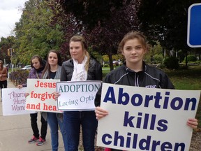 Teens from Holy Redeemer Parish Cluster take part in the National Life Chain which took place on Sunday, Oct. 5 in the downtown area. Life Chain is a peaceful and prayerful public witness of pro-life individuals standing for 60 minutes praying for our nation and for an end to abortion. It is a visual statement of solidarity by the Christian community that they support the sanctity of human life from the moment of conception until natural death and that abortion kills children. Many cars driving through the streets during the Life Chain could be heard honking and giving support.