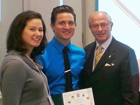 Troy Adams (centre) tands beside his wife Amy and MP Bev Shipley after receiving an award from the Brain Injury Association of Canada.
SUBMITTED PHOTO