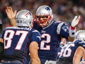 Patriots quarterback Tom Brady (right) reacts after a touchdown catch by tight end Rob Gronkowski (left) against the Bengals during third quarter NFL action in Foxborough, Mass., on Sunday, Oct. 5, 2014. (David Butler II/USA TODAY Sports)