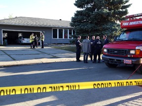 Fire investigators and police on scene at fatal fire at 172 st and 77 ave in Edmonton, Alberta on October 1, 2014. A woman was found deceased in the home and police are now investigating. Perry Mah/Edmonton Sun
