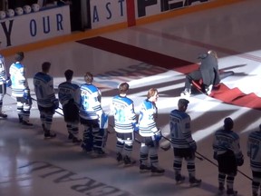 Vancouver Canucks anthem singer Mark Donnelly tripped over the ceremonial rug at centre ice prior to a B.C. Hockey League game on Friday, Oct. 3, 2014. (Penticton Vees/YouTube.com)