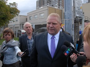 Doug Ford speaks with reporters outside of the GO Danforth Station Monday, Oct. 6, 2014. (SHAWN JEFFORDS/Toronto Sun)