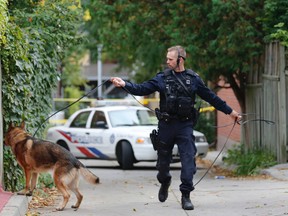 Police investigate the area on Traffan St. in Regent Park where a young man who shot to death on Monday, October 6, 2014. (Michael Peake/Toronto Sun)