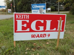 Ward 9 councillor Keith Egli's election sign is seen along with challenger Cristian Lambiri in the Knowdale-Merivale Ward on Tuesday Sept 30,  2014. 
Tony Caldwell/Ottawa Sun/QMI Agency