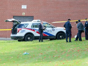 Toronto Police tend to a large crime scene at 2067 Islington Ave. after two youths were fatally shot Monday, October 6, 2014. (Dave Thomas/Toronto Sun)