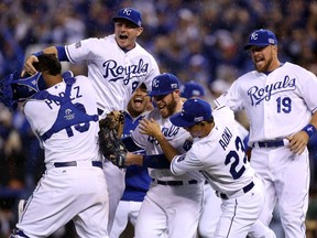 Greg Holland #56 celebrates with Norichika Aoki #23 of the Kansas City Royals after defeating the Los Angeles Angels 8-3 in Game Three of the American League Division Series. (Ed Zurga/Getty Images/AFP)