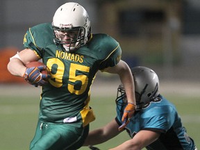 North Winnipeg Nomads Chris Simundson (l) breaks a tackle by Eastman Raiders Austin Catellier during midget football in Winnipeg Saturday October 27, 2012. On Monday, October 6, 2014, the Nomads dismissed head coach Max Hyde and the entire staff including managers and the trainer after a Nomads player was suspended Friday, October 3, 2014, after he 'knocked over a referee' and was ejected from a game against the Greendell Falcons.
BRIAN DONOGH/WINNIPEG SUN/QMI AGENCY