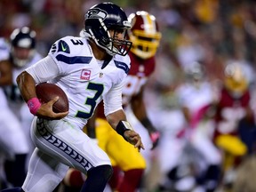 Quarterback Russell Wilson of the Seattle Seahawks rushes during the first half of a game against the Washington Redskins at FedExField on October 6, 2014. (Patrick Smith/Getty Images/AFP)