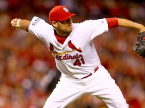 Cardinals’ John Lackey throws out Dodgers’ Carl Crawford at first base during Game 3 of the NLDS on Monday night at Busch Stadium in St. Louis. (AFP/PHOTO)