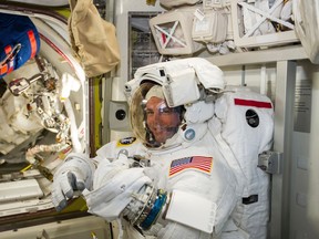 NASA astronaut Reid Wiseman checks his spacesuit in preparation for the first Expedition 41 spacewalk in this image released on October 7, 2014. (REUTERS/Alexander Gerst/NASA/ESA/Handout)