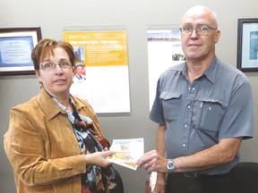 Deb Hartung, operations manager for the Vulcan County Health and Wellness Foundation, and Town of Vulcan Mayor Tom Grant buy the first tickets for the foundation’s Oktoberfest event, which is lined up for Oct. 18 starting at 7:30 p.m. at the Cultural-Recreational Centre. After the original allotment of 250 tickets sold out, organizers decided to release an additional 30 tickets, most of which are still available. 
Submitted photo