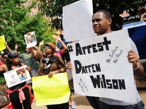Protestors at the St. Louis County Justice Center call for the arrest of Police Officer Darren Wilson in Clayton, Missouri in this August 20, 2014 file photo. (REUTERS/Mark Kauzlarich)