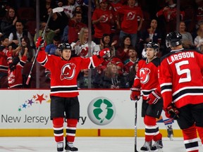 Jordin Tootoo #74 of the New Jersey Devils (L) celebrates a first period goal by Adam Larsson. (Bruce Bennett/Getty Images/AFP)
