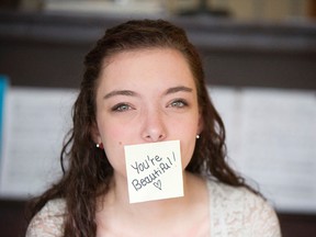Airdrie, Alta. - Caitlin Prater-Haacke poses with a sticky note in her family's home in the city's southwest on Tuesday, Oct. 7, 2014. The Grade 11 student at George McDougall High School was bullied last week and responded on Monday by posting upwards of 850 positive post-it notes on student and faculty lockers.
BRITTON LEDINGHAM / AIRDRIE ECHO / QMI AGENCY