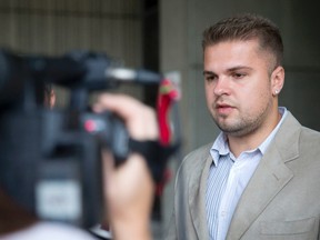 Irnes Zeljkovic talks with members of the media outside of the court house in London, Ontario after reaching a settlement in his lawsuit against Western University and their campus police on Tuesday October 7, 2014. (CRAIG GLOVER, The London Free Press)