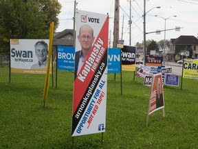 Election signs at the corner of Horton St. and Wharncliffe Road in London, Ontario on Thursday, October 2, 2014. (DEREK RUTTAN, The London Free Press)