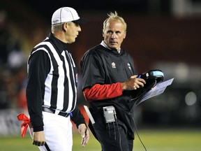 Calgary Stampeders coach John Hufnagel doesn't throw the challenge flag a whole lot, but has won most of his disputes this season. (Reuters)