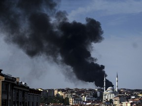 Smokes rises from the Gaziosmanpasa district on Oct. 7, 2014, in Istanbul during a demonstration against attacks launched by Islamic State insurgents targeting the Syrian city of Kobane and lack of action by the government. (AFP/Ozan Kose)
