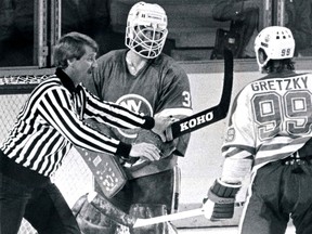 National Hockey League (NHL) linesman Swede Knox moves in to stop New York Islanders goalie Billy (Hatchet Man) Smith from waving his stick in the face of Edmonton Oilers centre Wayne Gretzky on Thursday, May 12, 1983, during game two of the Stanley Cup finals. The Islanders went on to win their fourth straight championship by sweeping  the Oilers  4-0. Edmonton Sun/QMI Agency