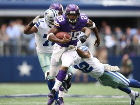 Minnesota Vikings running back Adrian Peterson (28) runs with ball against the Dallas Cowboys in the first quarter at AT&T Stadium on Nov 3, 2013 in Arlington, TX, USA. (Matthew Emmons/USA TODAY Sports)