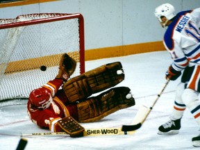 Edmonton Oilers forward Mark Messier watches the puck go in the net against Calgary Flames goalie Reggie Lemelin during the second round of the 1984 Stanley Cup Playoffs action in Edmonton. (Edmonton Sun/QMI Agency)