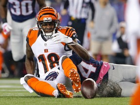 Cincinnati Bengals wide receiver A.J. Green (18) fumbles the ball under pressure from New England Patriots cornerback Darrelle Revis (24) during the second quarter at Gillette Stadium. (David Butler II-USA TODAY Sports)