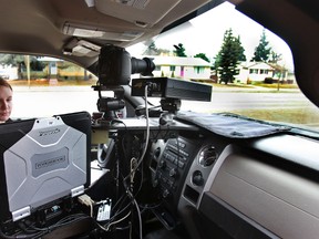 A peace officer operates a photo radar camera in Edmonton.