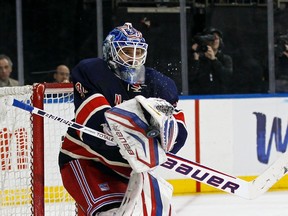 New York Rangers goalie Henrik Lundqvist makes a save against the Toronto Maple Leafs in overtime period action during their NHL hockey game at Madison Square Garden in New York April 10, 2013.    REUTERS/Adam Hunger