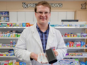 Trevor Bills the pharmacy manager at Life Med Pharmacy in Whitecourt, Alta. on Friday, Oct. 3, 2014, is pictured holding the contents of the safer injection kits that Life Med will be distributing to people who who use injection drugs.  The kits are provided to those who need them free of charge, they are provided by HIV West Yellowhead as part of their new harm reduction program in rural Alta. The program is the first rural-based program of it's kind in the province. The kits contain two clean needles, a sharps disposal kit and distilled water.
