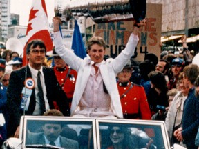 Sandy Mako, driving, and Harold Bakke, passenger, in the car with Oilers captain Wayne Gretzky holding the Stanley Cup high as he and the rest of the team makes its way through a jam packed downtown Edmonton during the celebration parade on May 22, 1984. The Oilers won their first Stanley Cup Championship on May 19, 1984 in Edmonton at the Northlands Coliseum by beating the New York Islanders in five games. Edmonton Sun/QMI Agency