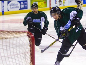 Max Domi watches Mitch Marner work on a scoring drill at practice on Wednesday. (MIKE HENSEN, The London Free Press)