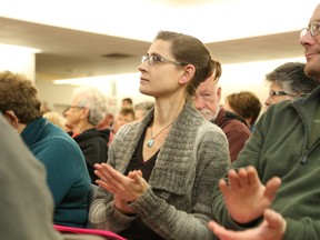 Julie Bryson listen attentively as Thurlow's eight council candidates address residents gathered at the Gerry Masterson Community Centre Wednesday night. Jason Miller / The Intelligencer