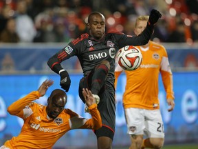 TFC midfielder Jackson (right) battles for the ball with Houston Dynamo defender DaMarcus Beasley at BMO Field last night. (USA Today Sports)