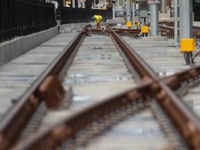 A worker grinds concrete on the LRT tracks near NAIT in Edmonton, Alta., on Wednesday, Oct. 8, 2014. The Metro LRT line opening has been delayed until Feb. 2015 at the earliest according to the City of Edmonton. Ian Kucerak/Edmonton Sun/ QMI Agency