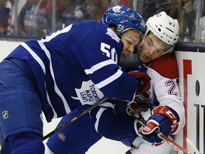 Maple Leafs defenceman Stuart Percy checks Canadiens' Alex Galchenyuk on Oct. 8. (Craig Robertson, Toronto Sun)
