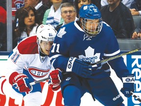 Montreal’s Lars Eller tries to check the Leafs’ David Clarkson, wearing a full face mask to protect his broken orbital bone. (Craig Robertson/Toronto Sun)