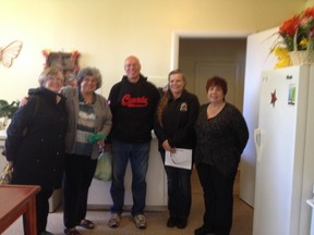 Volunteers Sharon Martin, Karen Allard, Gary Martin and Linda Archibald partner rep for APANO, Virginia Forsythe the partner rep for OAHAS pose in the kitchen of St. Paul's United Church.